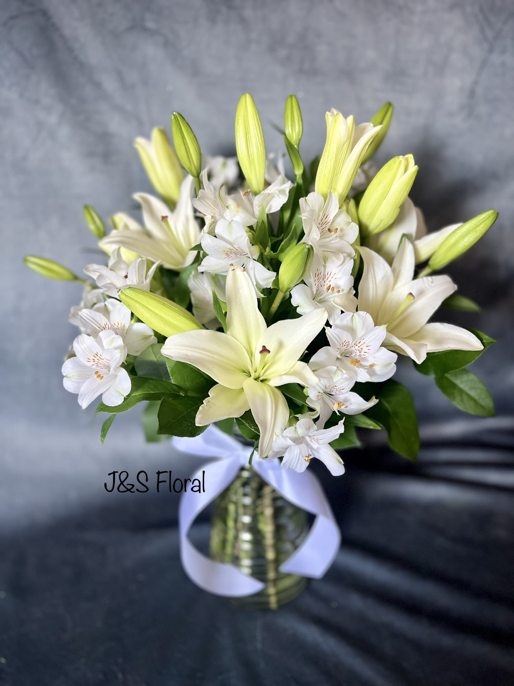 Peaceful Evening  - White lilies and Alstroemerias stand tall and beautiful. Send an impactful gift to somebody whether it be for saying sorry for your loss or celebrating loved ones. This arrangement instantly elevates any room and fills the space with peace. 