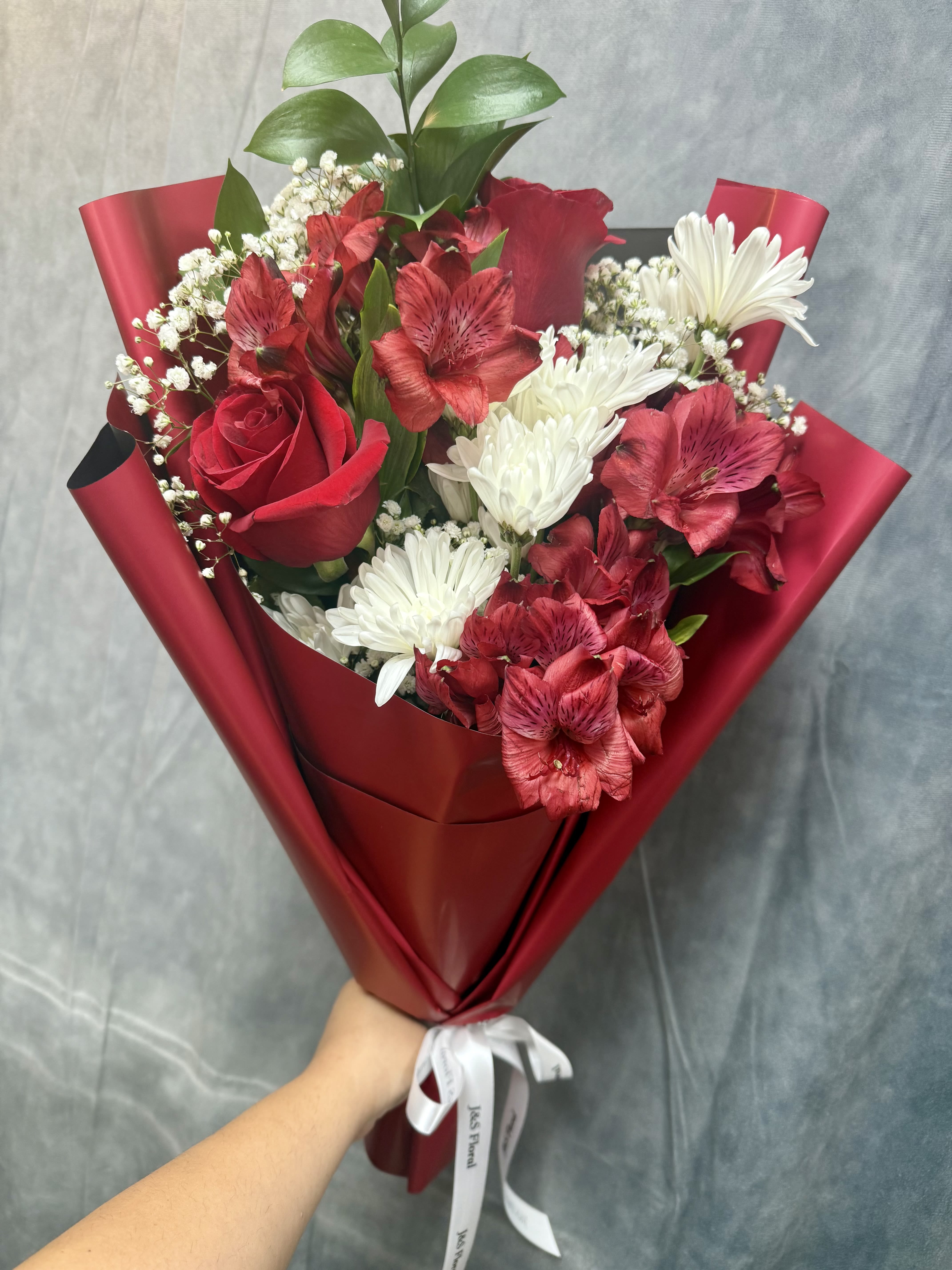 Red and white mixed bouquet with roses, daisies, and alstroemeria
