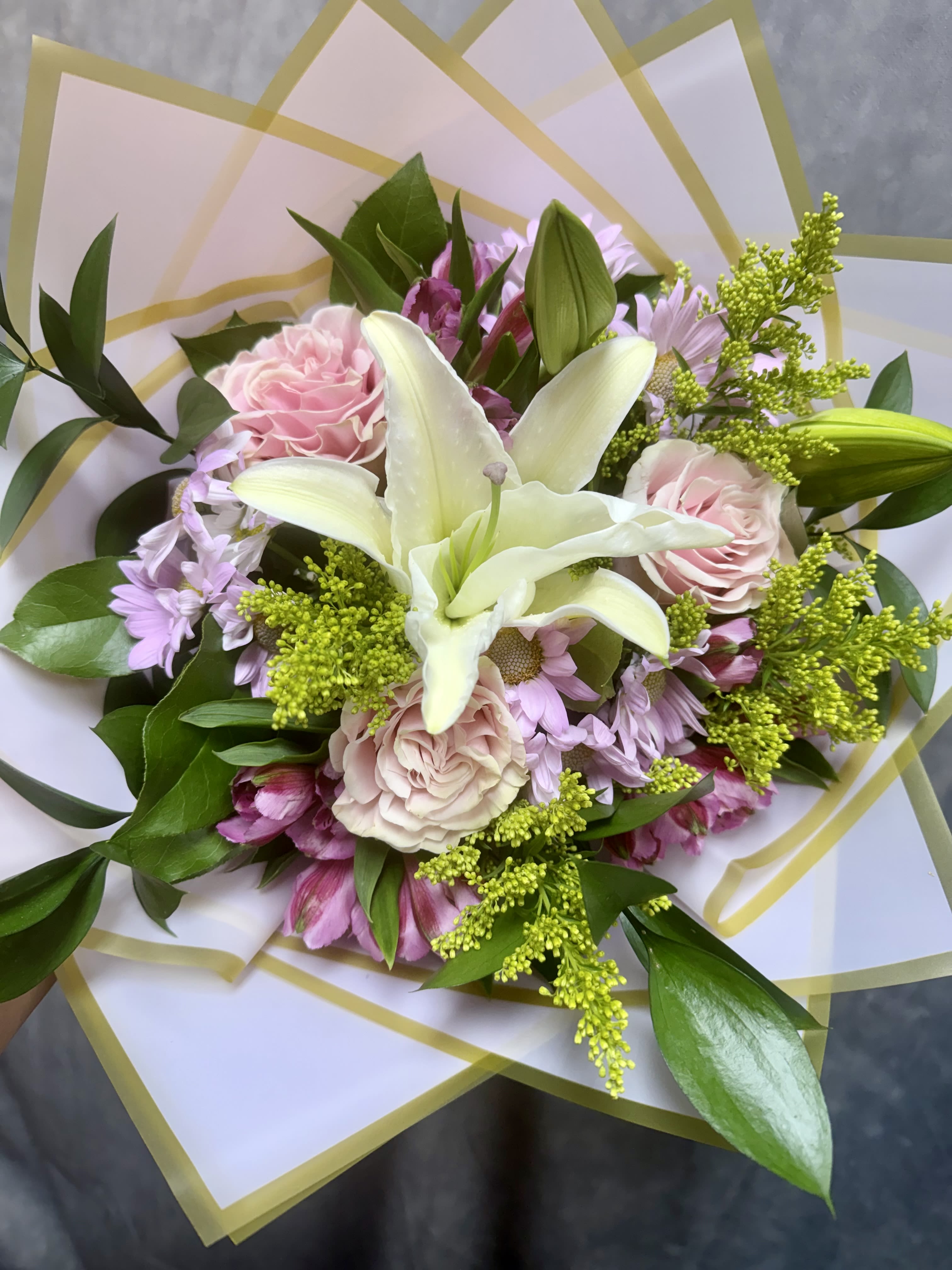 Bouquet of pink and white flowers wrapped in translucent paper