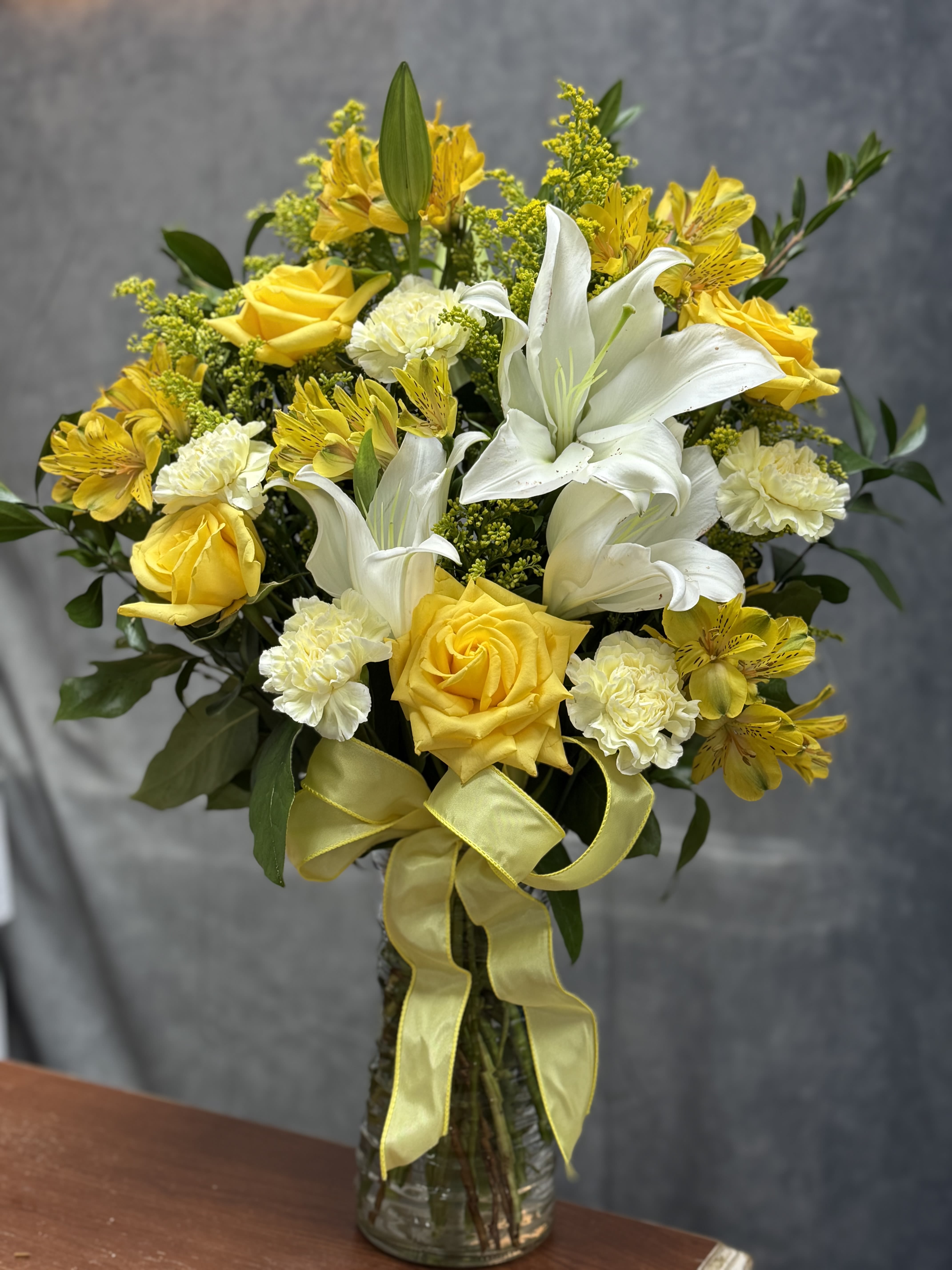Yellow breeze - A refreshing blend of vibrant yellow roses and spray roses , yellow alstroemeria and elegant white lilies , capturing the essence of gentle breeze . Perfect for spreading warmth , joy and positivity in any space.
