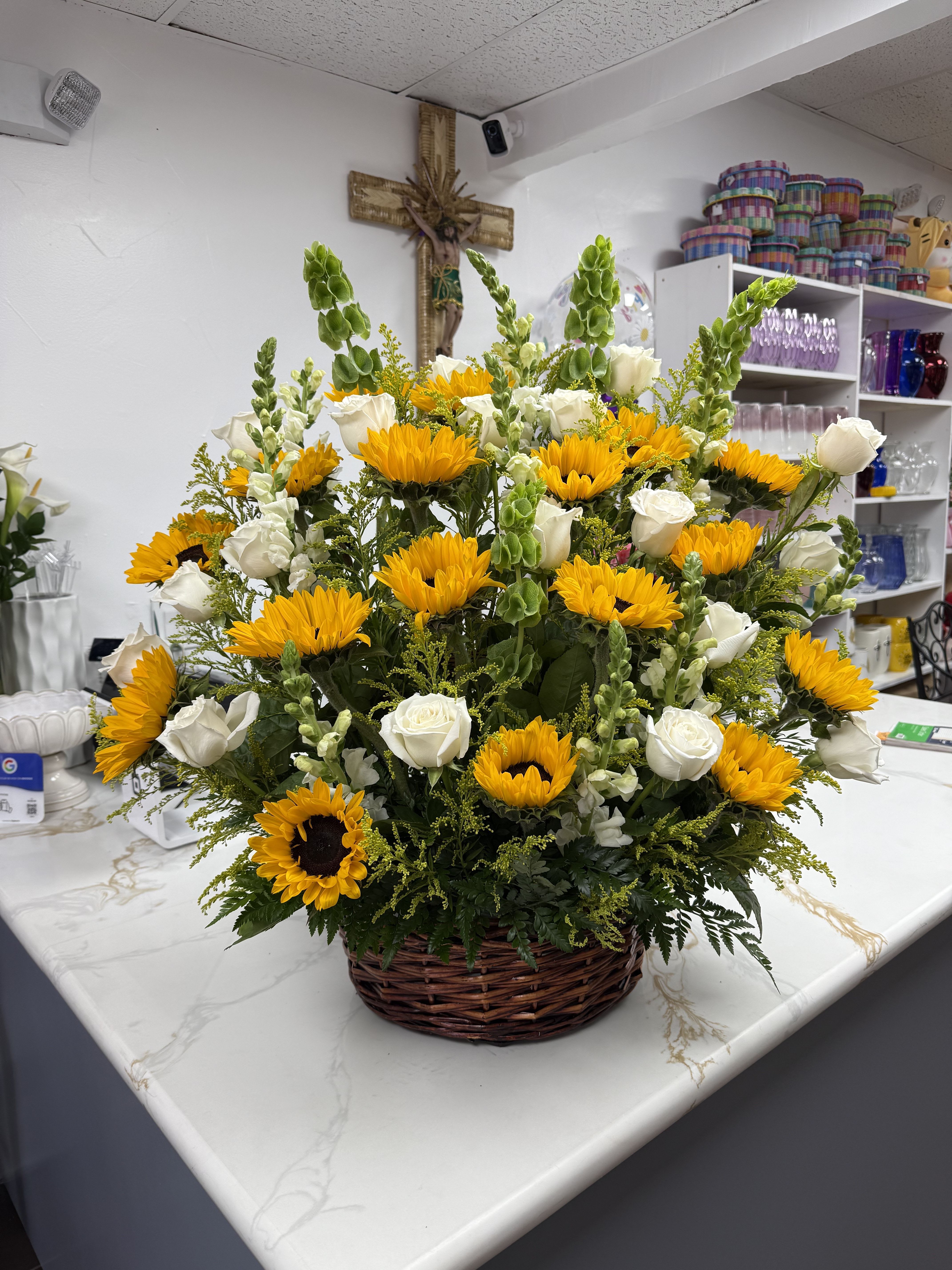 Basket arrangement of yellow sunflowers and white roses