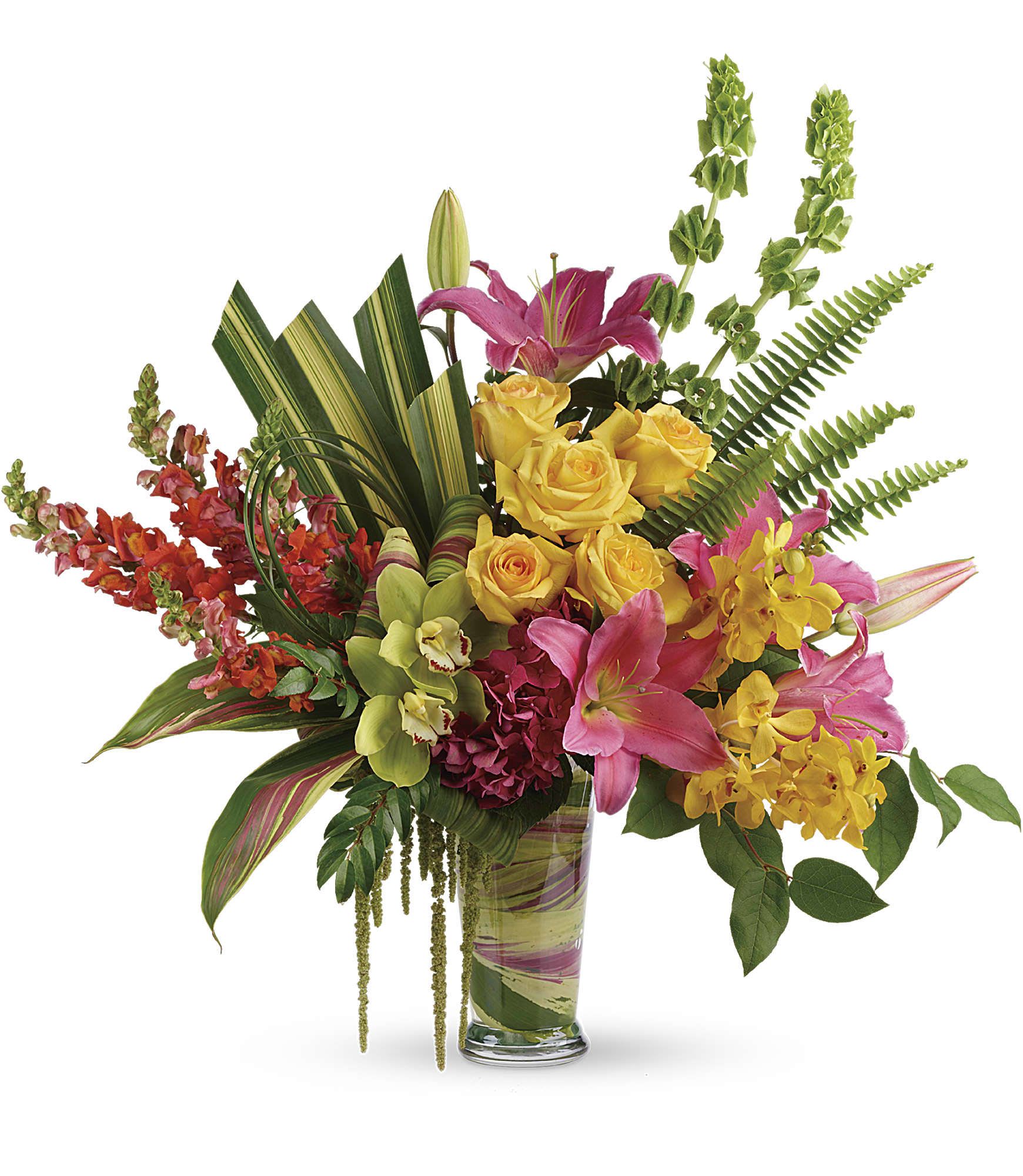 Mixed bouquet of pink lilies, yellow roses, and orchids in a glass vase