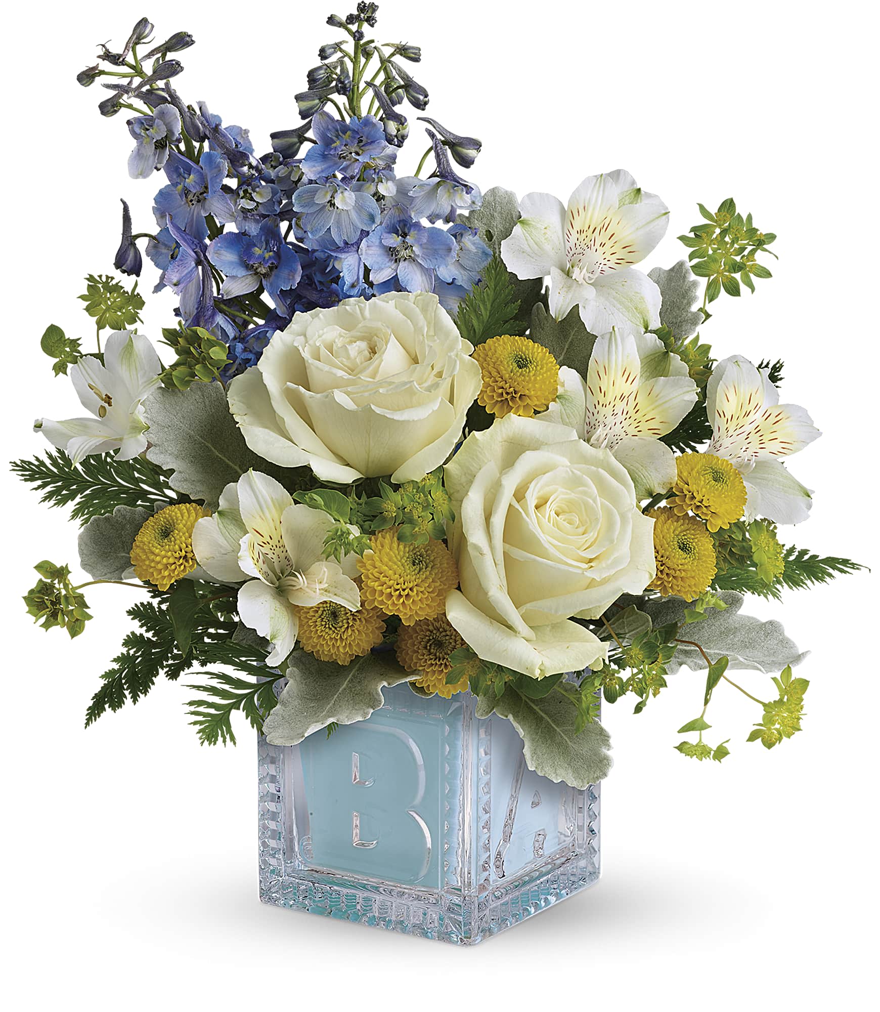 Bouquet of white roses, blue flowers, and yellow blooms in a glass cube vase