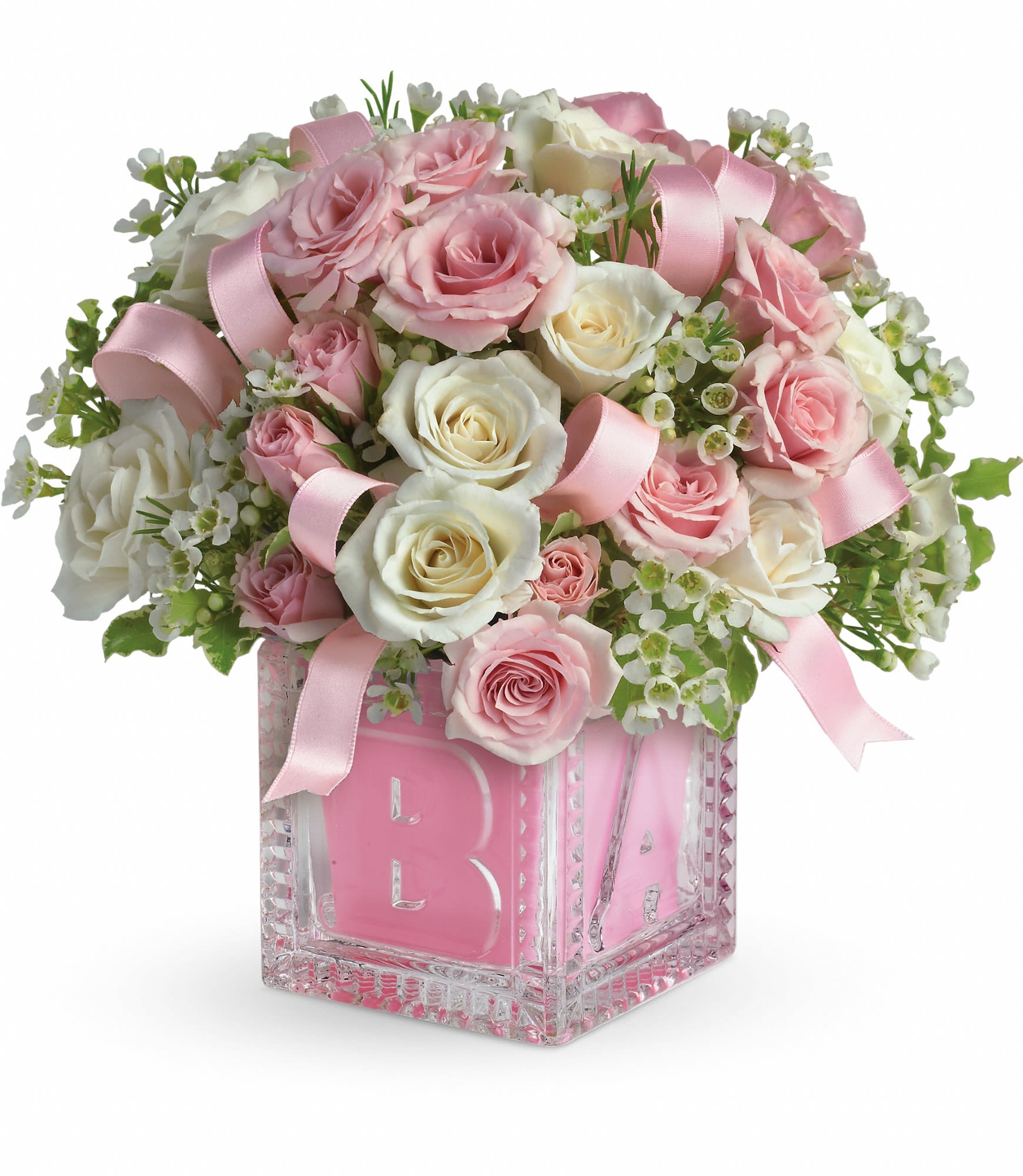 Pink and white rose arrangement in a glass block vase with a pink ribbon