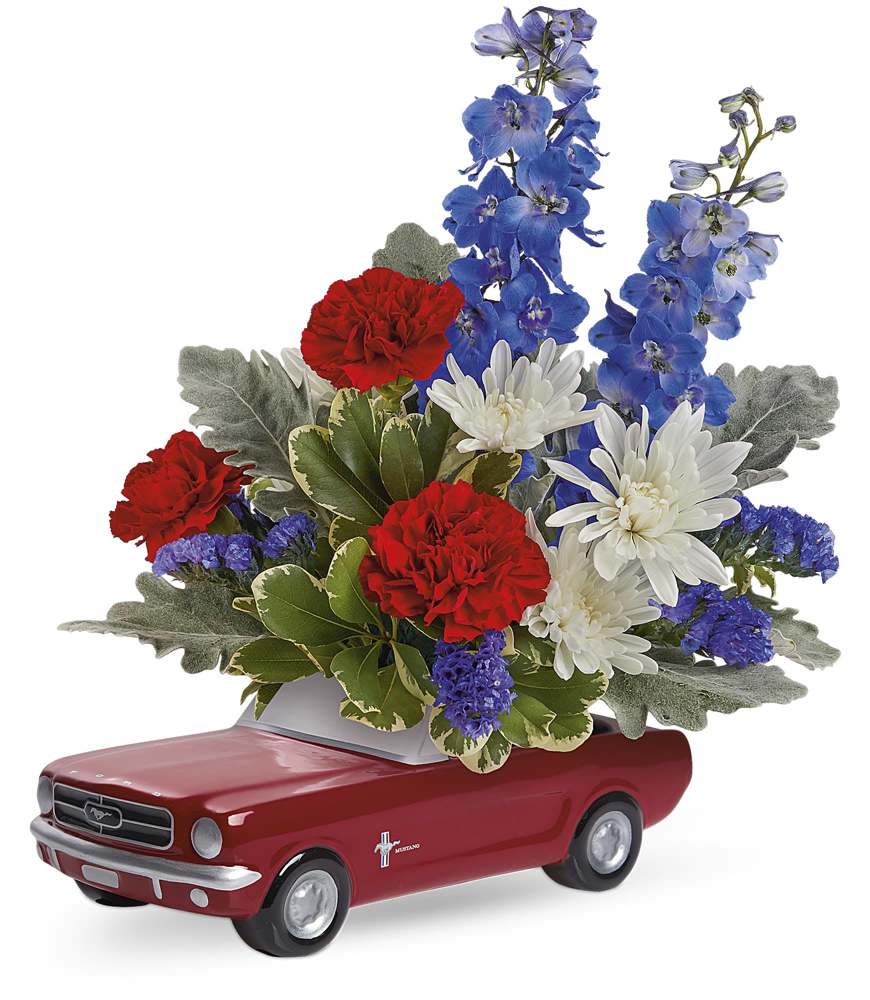 Floral arrangement in a red toy car container with red, white, and blue flowers