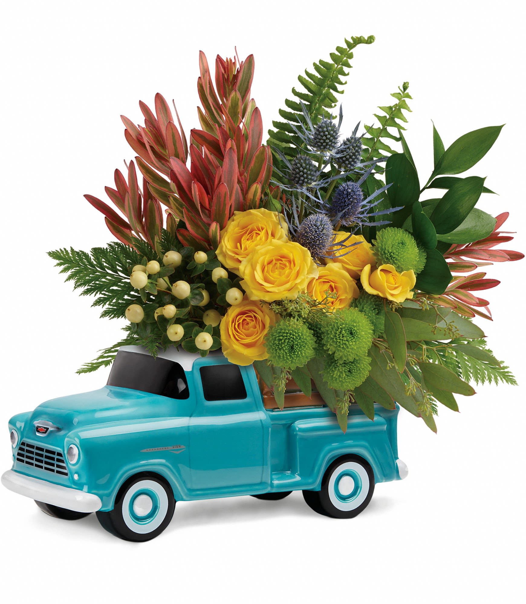 Yellow roses arranged in a turquoise ceramic truck