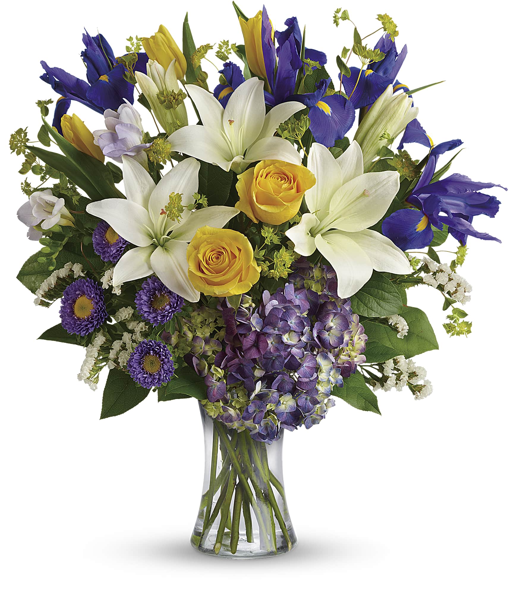Bouquet of white lilies, yellow roses, purple irises, and hydrangea in a glass vase