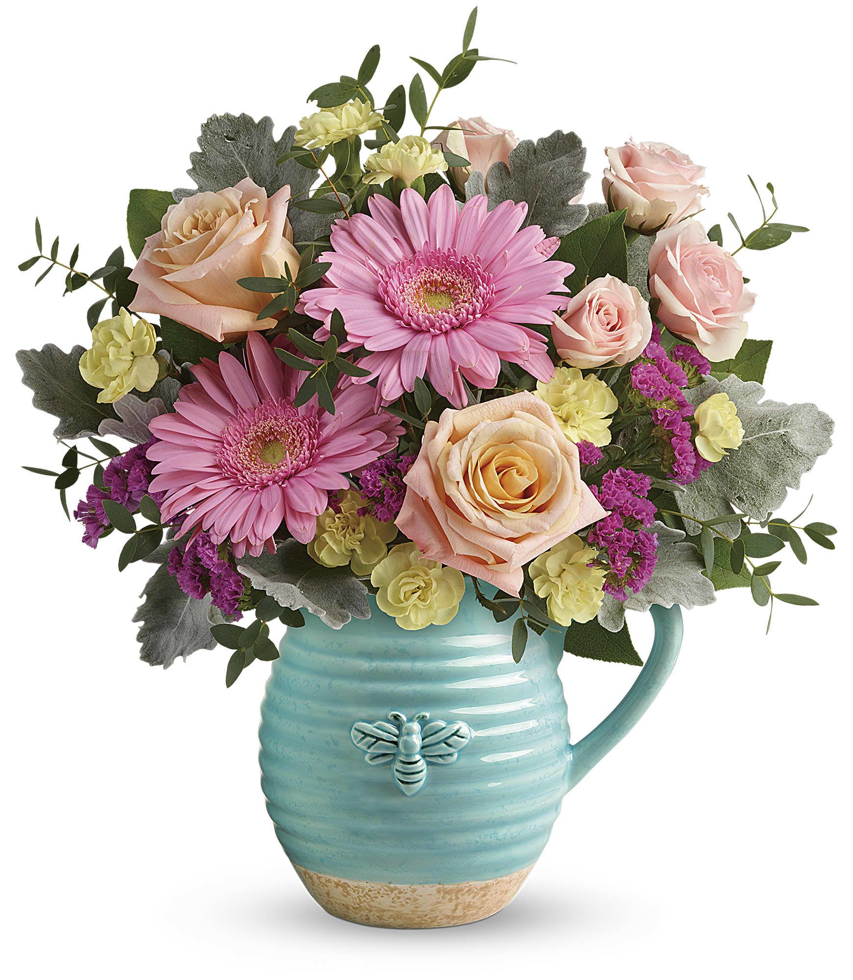 Pink gerbera daisies and roses in a turquoise mug vase