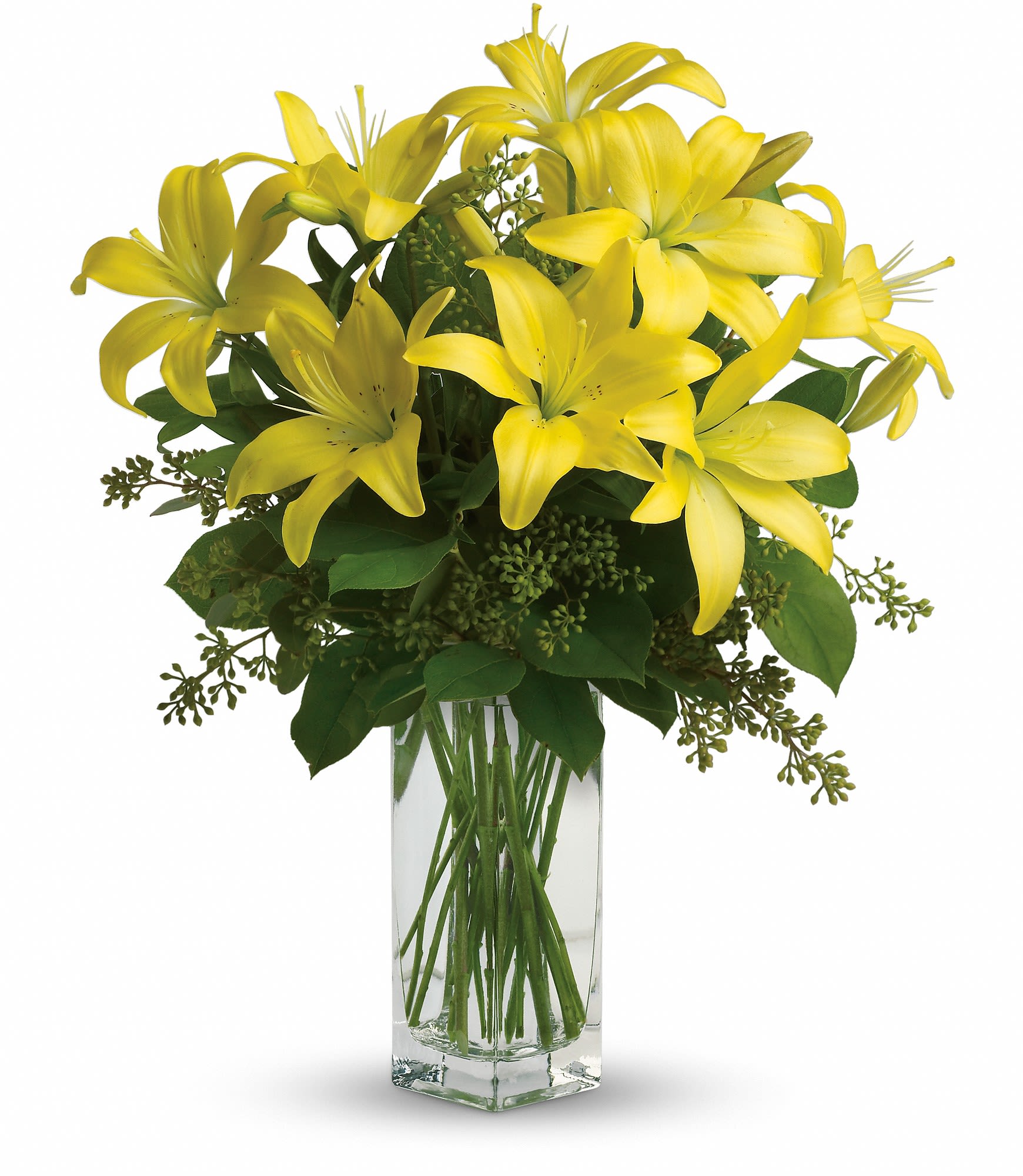 Yellow lilies arranged in a clear glass vase