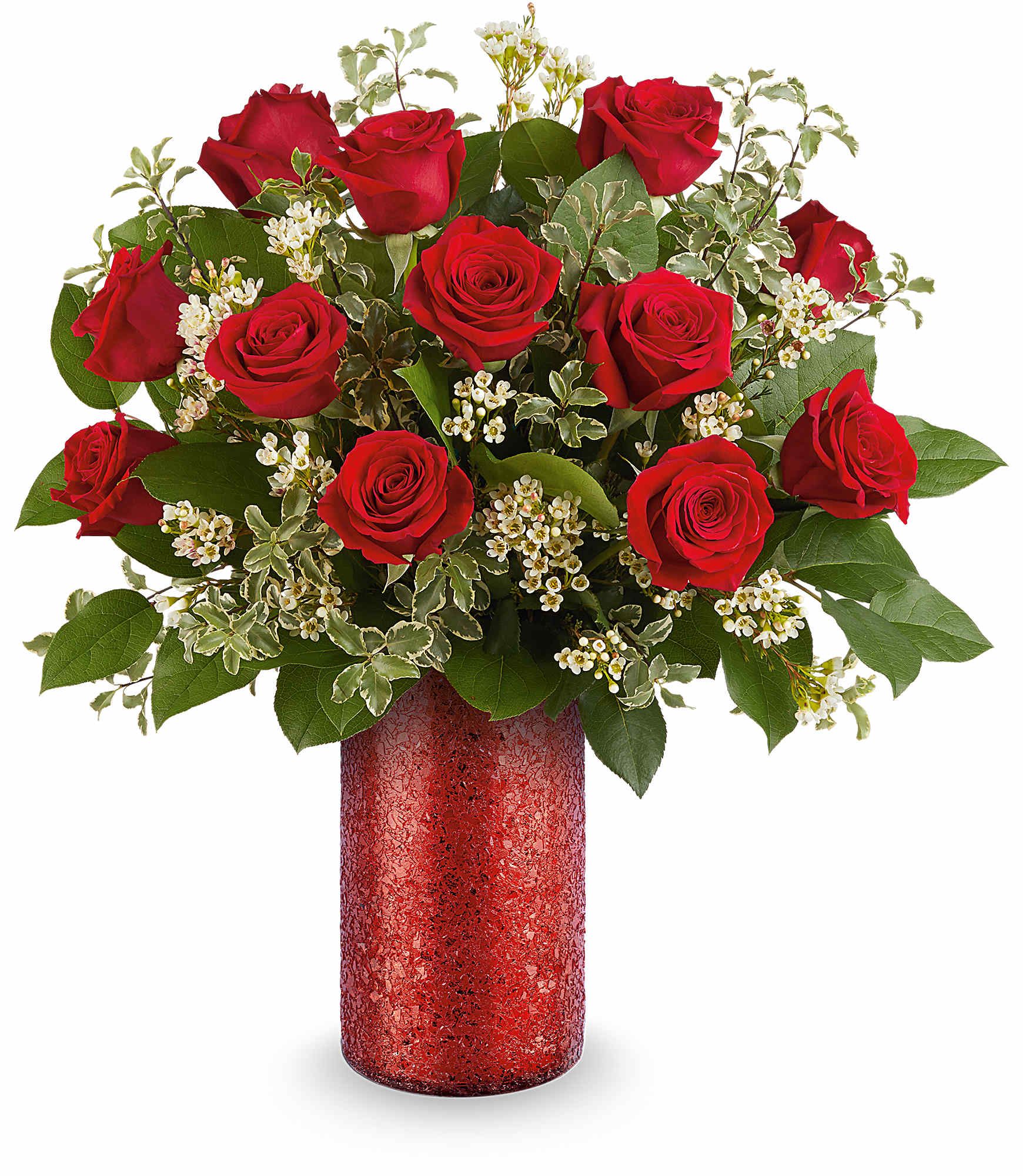Red roses arranged in a red vase with white filler flowers
