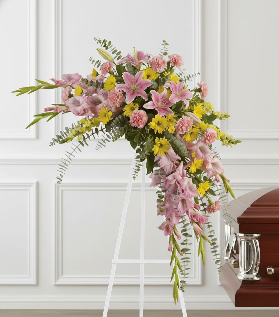 Sweet Solace Spray - Rejoice with this softly dramatic cascade of pink and yellow blooms - lilies, gladioli and chrysanthemums - that has hints of eucalyptus and variegated greens.