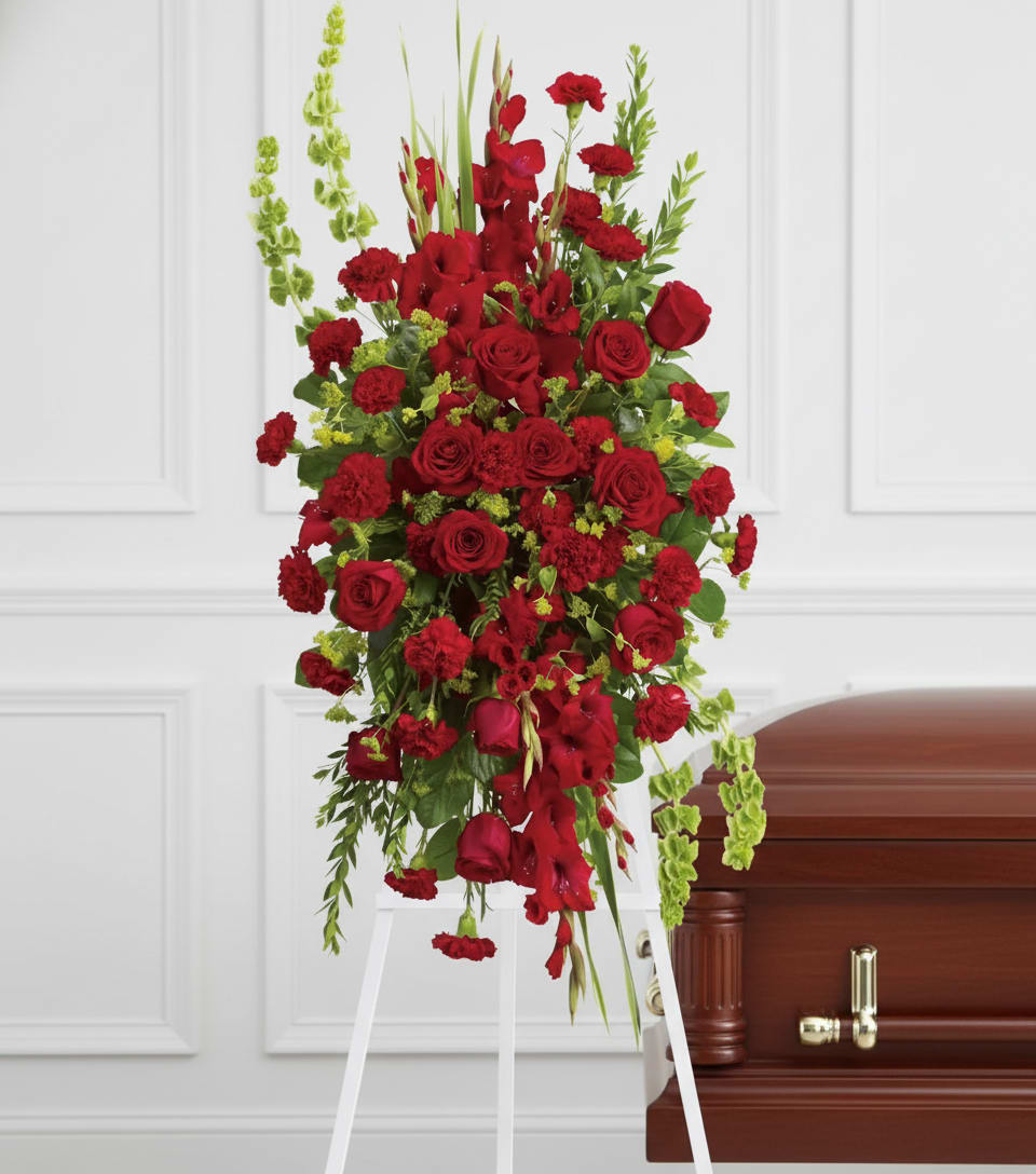 Care and Compassion Spray - Your care and compassion will be appreciated by all who lay eyes on this radiant standing spray. A variety of lovely vibrant red blossoms contrasted by vivid green of bells of Ireland will deliver your heartfelt condolences. Perfectly.