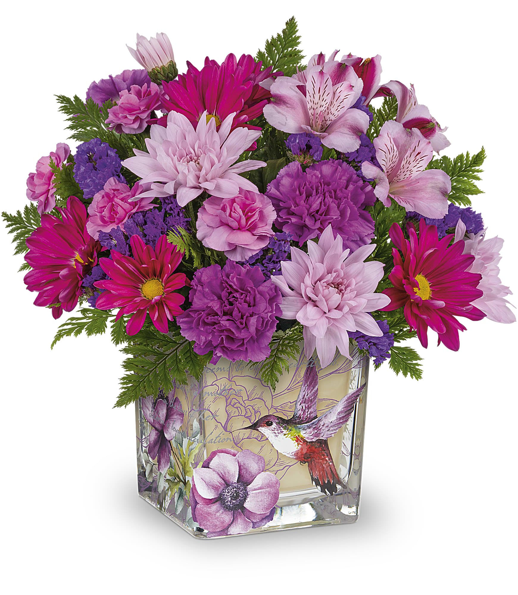 Love In Flight Bouquet - A lively bouquet of pink, purple, white, and green blooms that feels like a cheerful visit from spring-perfect as a birthday bouquet, a "thinking of you" surprise, or a bright anniversary arrangement. The Love In Flight bouquet pairs alstroemeria, ruffled carnations, chrysanthemums, and daisy-like blooms into a full, layered shape that reads feminine and joyful; the hummingbird-and-floral print on the square glass vase gives the whole design a whimsical, uplifting touch your recipient will notice right away.  Dense clusters of magenta, lavender and soft pink flowers sit against bright green foliage for fresh contrast and a textured, garden-fresh appearance. The clear square vase keeps stems neat and shows off the arrangement's compact, generous proportions while the decorative print adds personality without overpowering the flowers. This is the kind of bouquet that makes someone feel genuinely seen-bright, playful, and unmistakably celebratory.  Ideal for everyday gifting, springtime gestures, or making a birthday morning feel special; it arrives ready to display in the included square glass vase. For best enjoyment, keep the vase topped with fresh water and placed out of direct sunlight to extend the life of the blooms.
