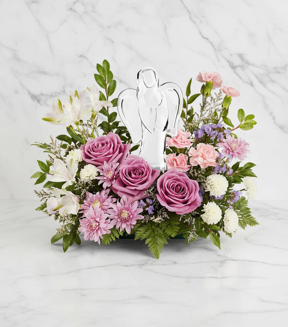 In Heaven's Arms Bouquet - Bring peace and comfort with our In Heaven's Arms Bouquet, featuring soothing lavender roses and soft pink blooms surrounding a luminous crystal angel keepsake-an elegant symbol of love's everlasting light.