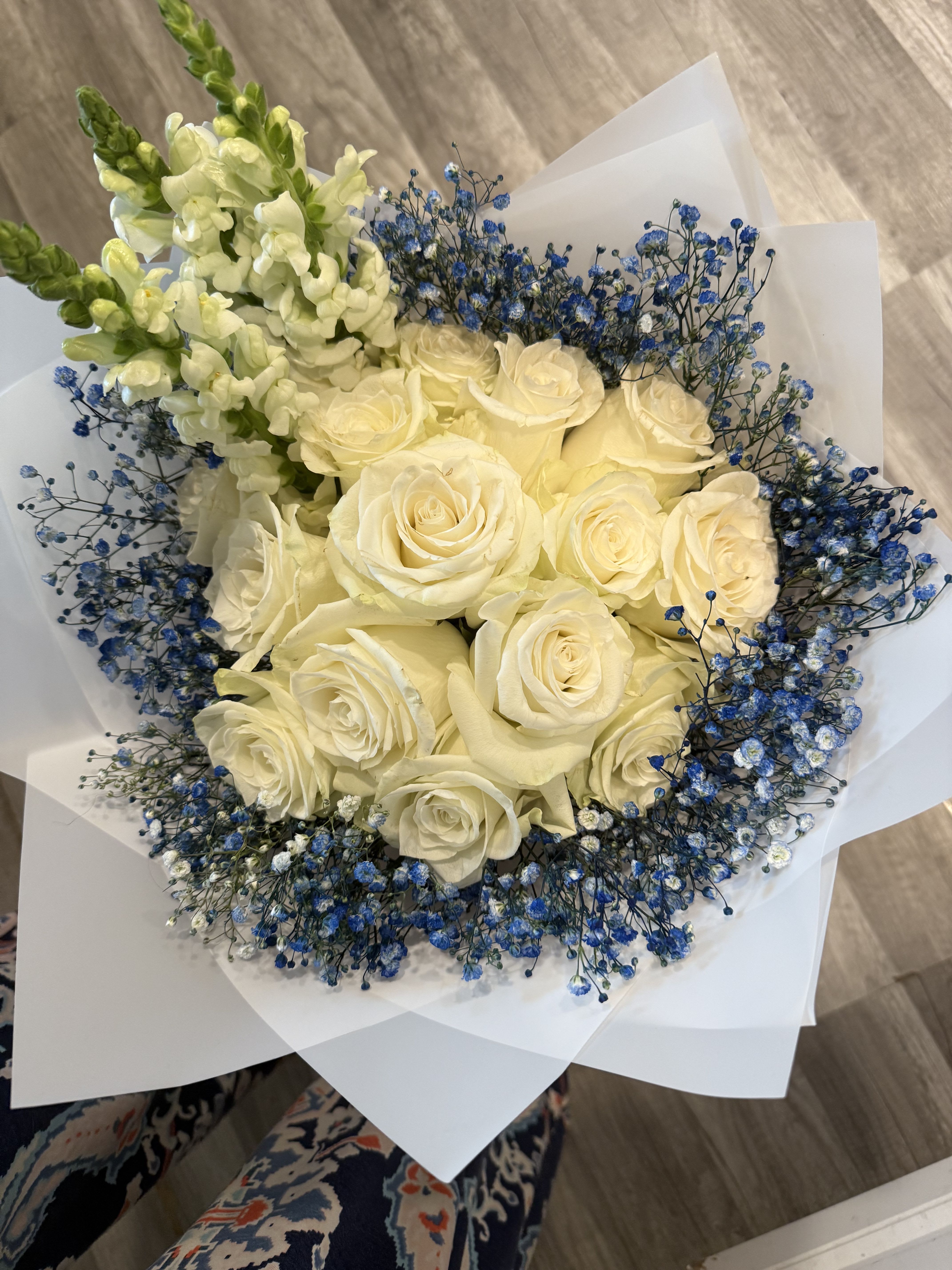 Bouquet of cream roses with blue baby's breath and white snapdragons