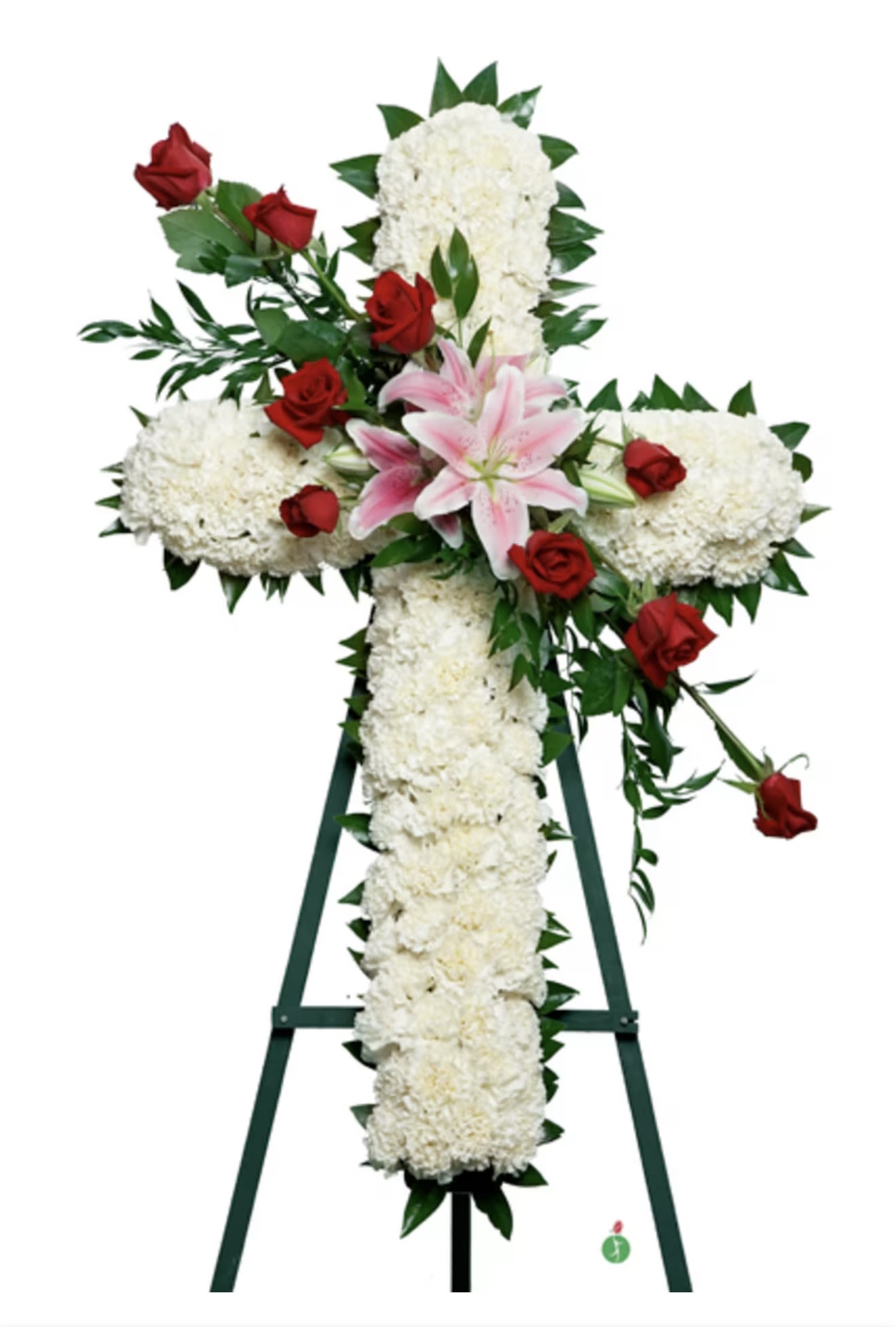 White floral cross with red roses and pink lilies on an easel