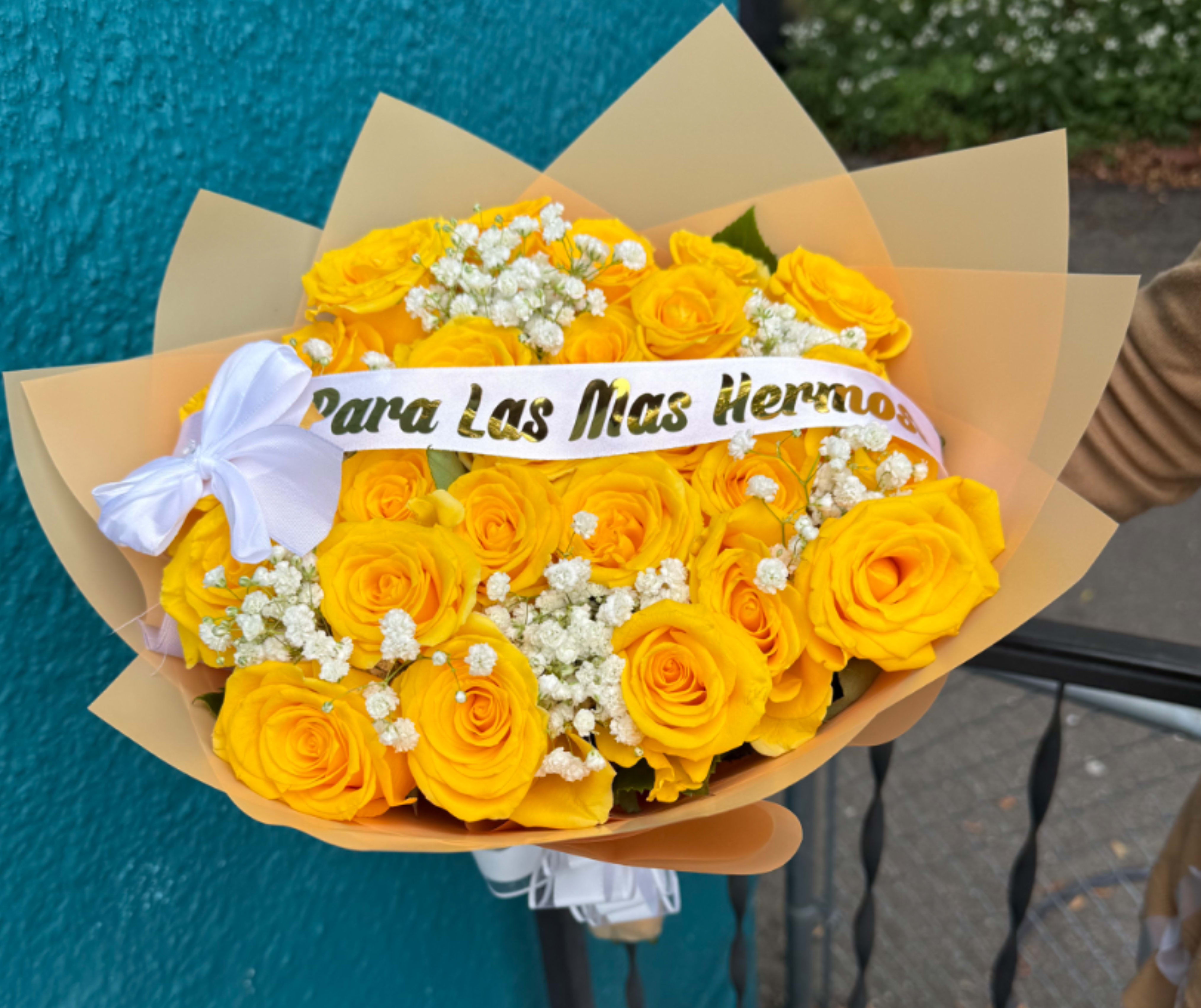 Yellow rose bouquet with white baby's breath and a white ribbon