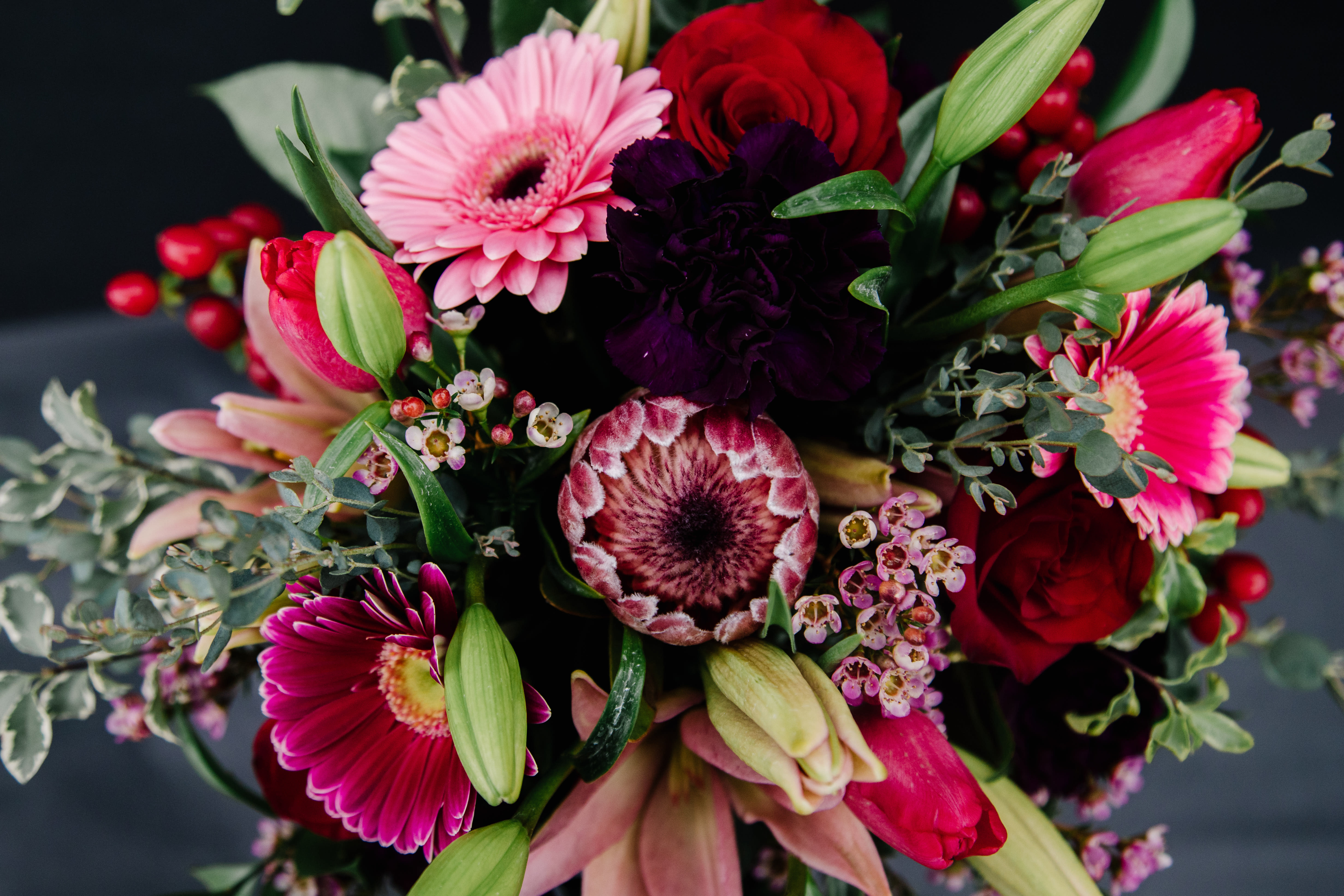 Mixed bouquet with pink gerberas, red roses, and lilies