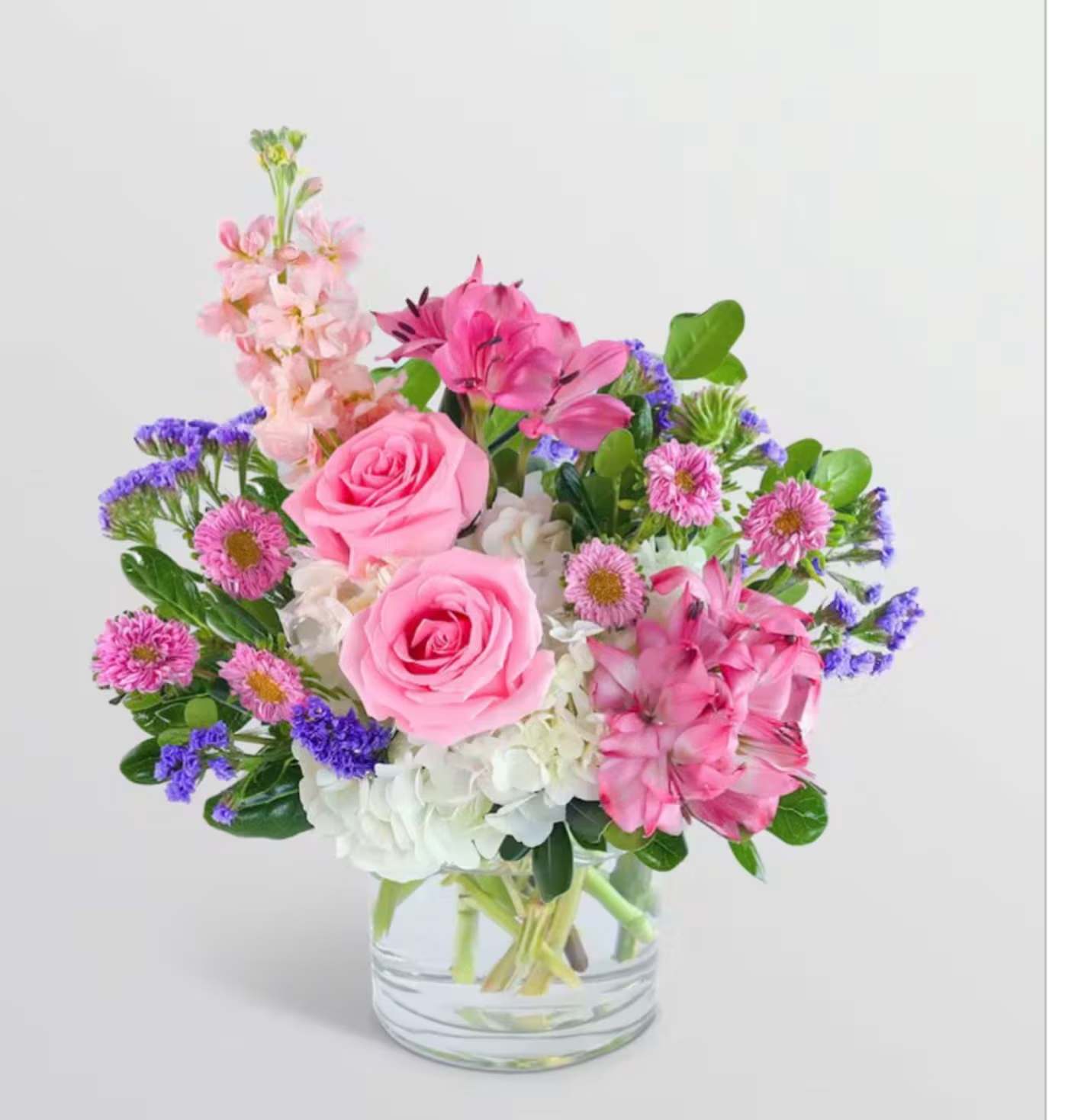 Pink and purple mixed bouquet in a clear glass vase