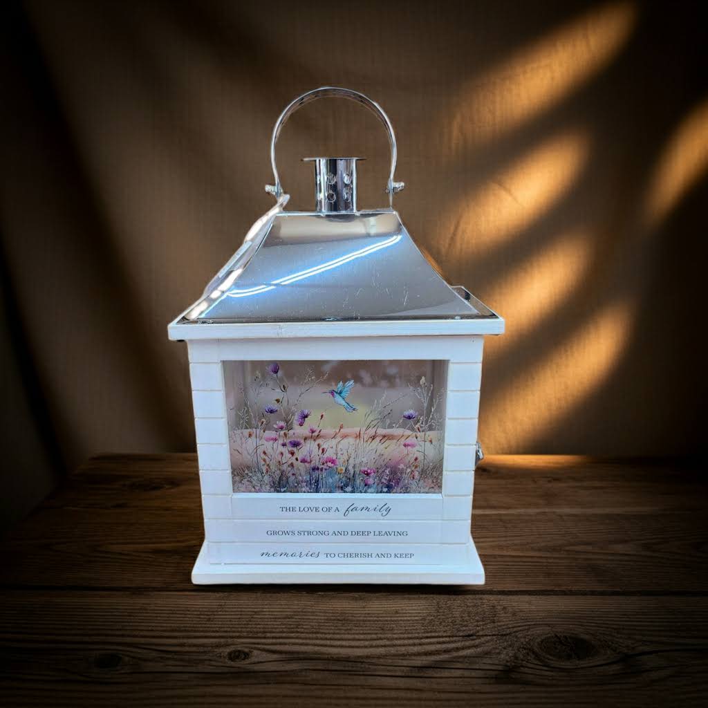 Lantern The Love Of A Family White- Huntsville sympathy delivery - 15" by 7" Lantern with flameless candle. Inscribed with The Love Of A Family Grows Strong And Deep Leaving Memories To Cherish And Keep 3 Triple A Batteries Required. Batteries Included.