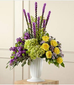 The FTD® Affection™ Arrangement - Contrasting blooms of purple, green and yellow create an original and beautiful expression of sympathy and sorrow, eminently appropriate for celebrating a life that has passed. This stately arrangement handcrafted by a local FTD artisan florist features an eye catching silhouette of purple liatris stretching heavenward surrounded by yellow roses, purple stock, lavender Monte Casinos and green hydrangea and button poms in a pedestal urn with the look of fine white ceramic. This "statement bouquet" makes a welcome addition to a wake, funeral or graveside burial service.  Your purchase includes a complimentary personalized gift message.