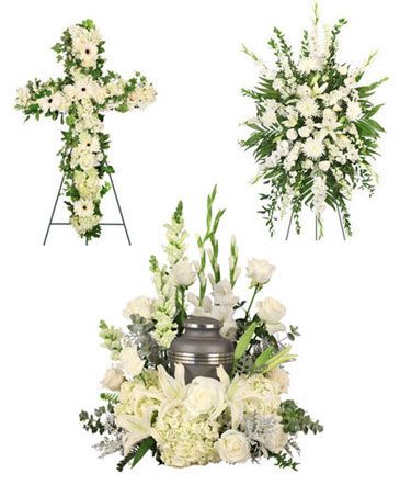 White funeral floral set with a cross, standing spray, and urn arrangement
