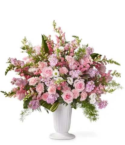 Pink and lavender floral arrangement in a white vase