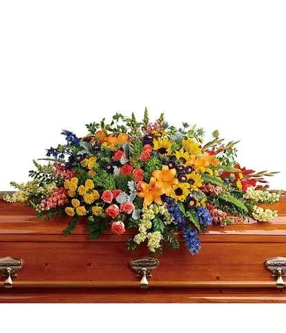 Colorful floral spray on a wooden casket