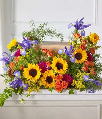 Bright mixed bouquet with sunflowers, purple irises, and orange roses