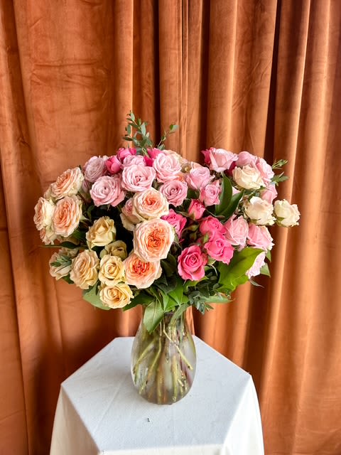 A Hundred Little Blessings - A hundred tiny roses, each one whispering beauty, joy, and gratitude. This luxurious garden-style arrangement blends soft pastel tones in a graceful glass vase — a stunning expression of love, admiration, and timeless elegance. * Not available for same day orders. Colors may vary based on availability. 