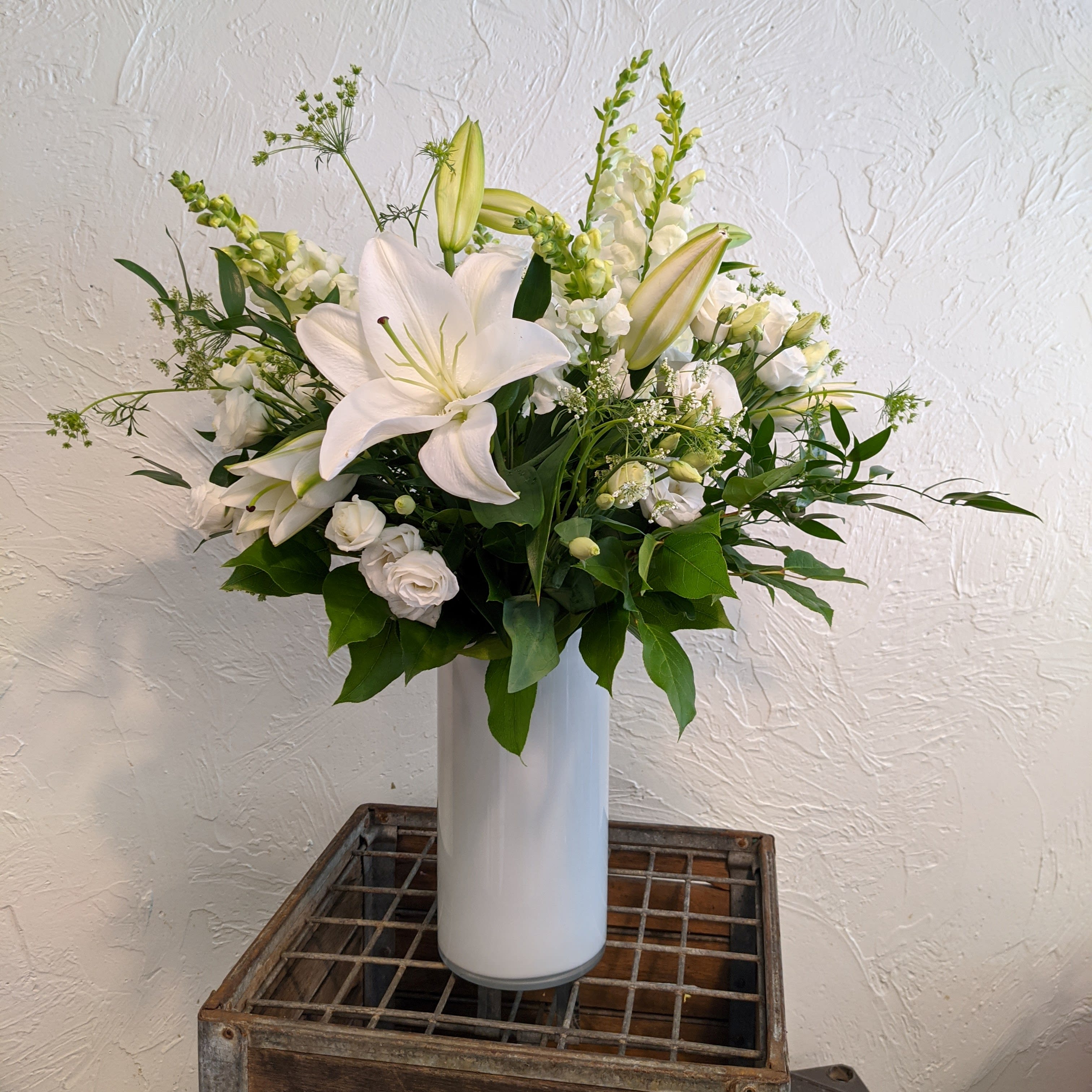 Sympathy Arrangement in White - *For any range of custom sympathy arrangements, please give us a phone call* A tasteful, elegant mix of white and green flowers in a tall glass vase. As in all our designs, our sympathy arrangements are full of gorgeous blooms - always fresh and beautiful, with very few fillers. We can also add color, whether muted tones or bright— just leave a comment with your order, or give us a call. 