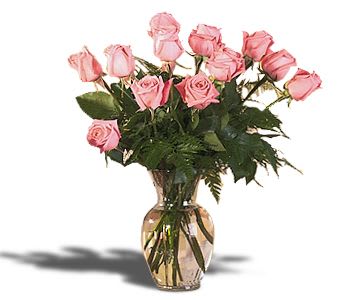 Pink roses arranged in a clear glass vase