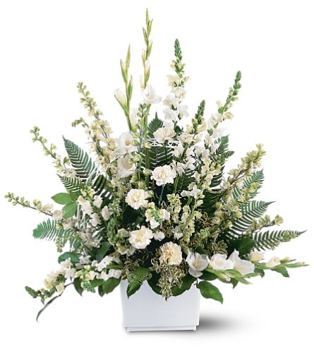 White floral arrangement in a white rectangular container