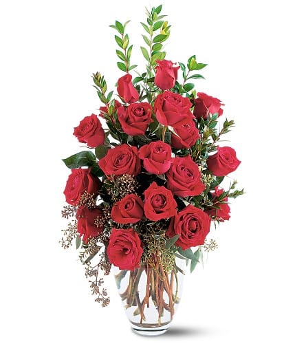 Tall bouquet of red roses in a clear glass vase