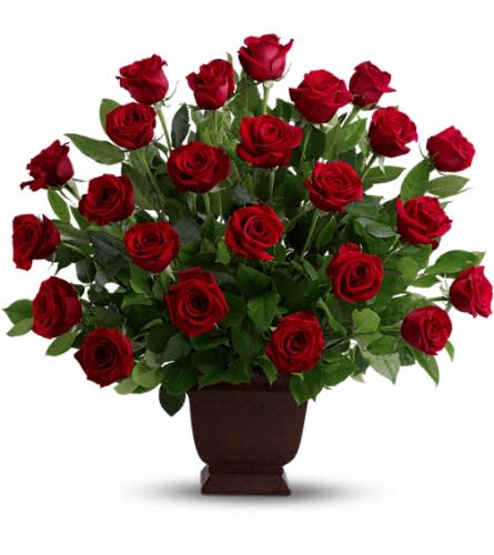 Red roses arranged in a brown urn vase