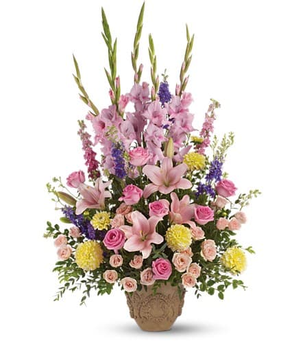 Tall pink and purple floral arrangement in a decorative vase