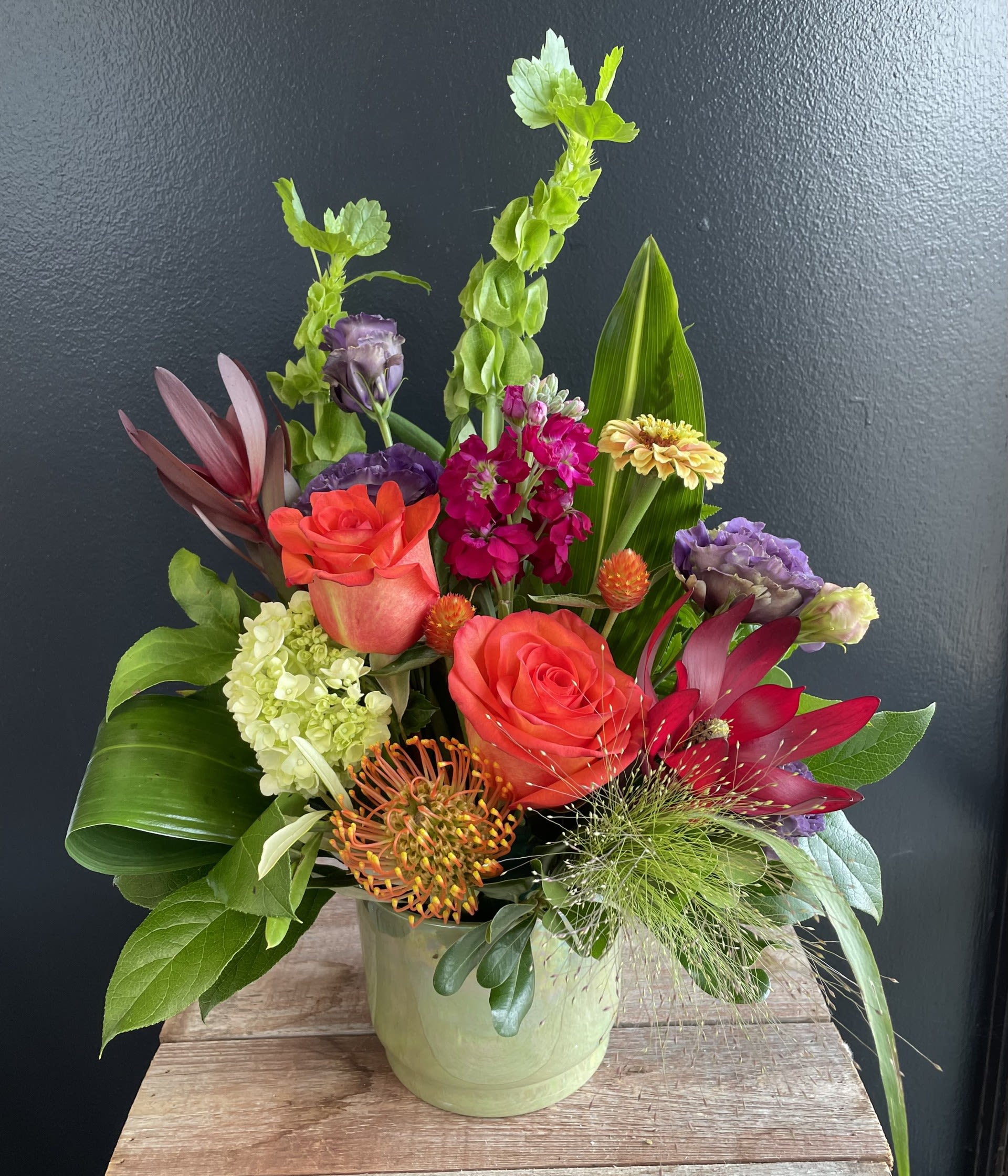 Tropical Bliss  - Experience the vibrant allure of the tropics with this dazzling Tropical Paradise arrangement. Bursting with the bold, exotic hues of paradise.  Vessel color and floral colors may vary 