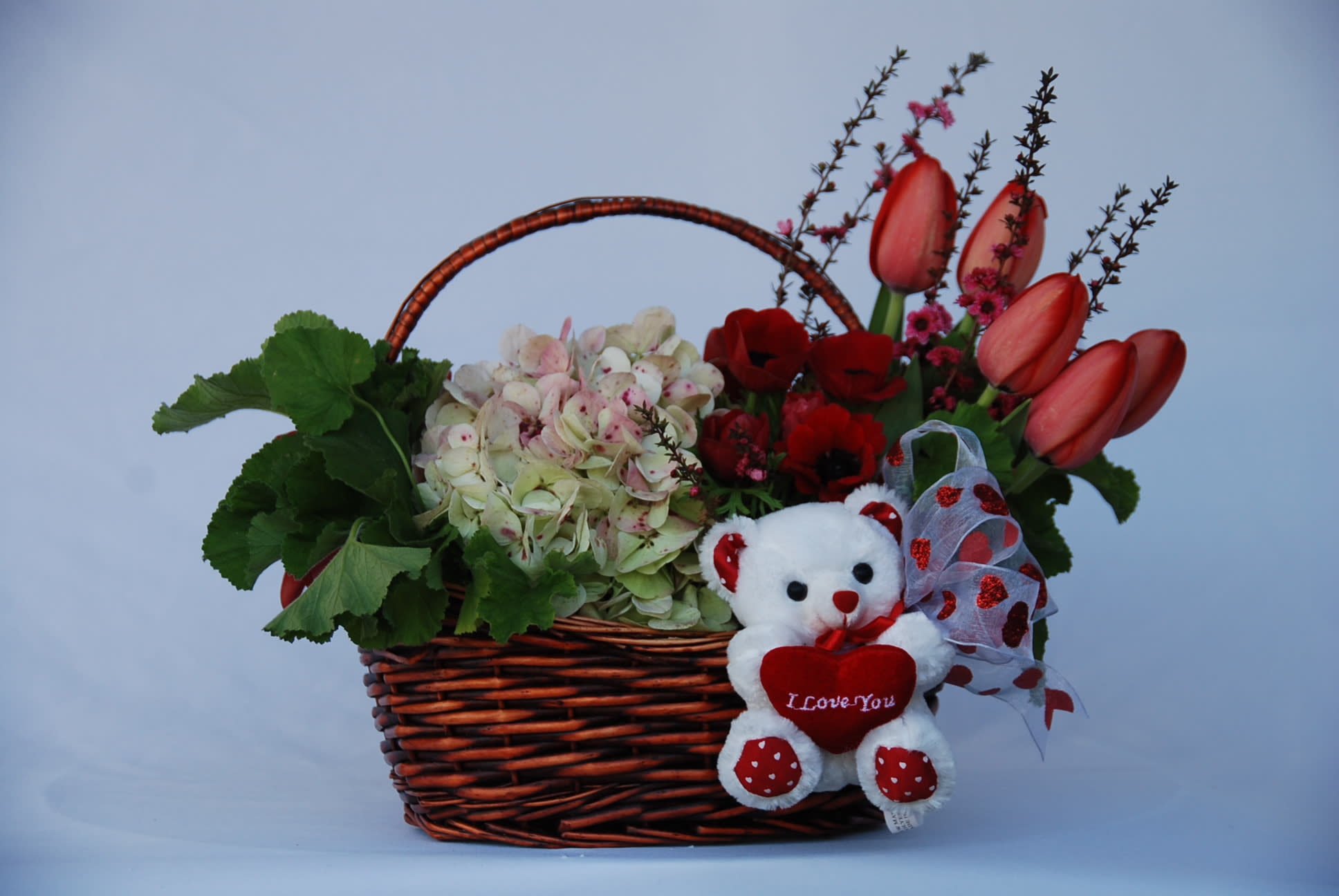 Basket of Love - A sweet basket filled with hydrangeas, tulips, roses, anemones and a little teddy bear good for Anniversary, Valentin's Day &amp; I Love You.