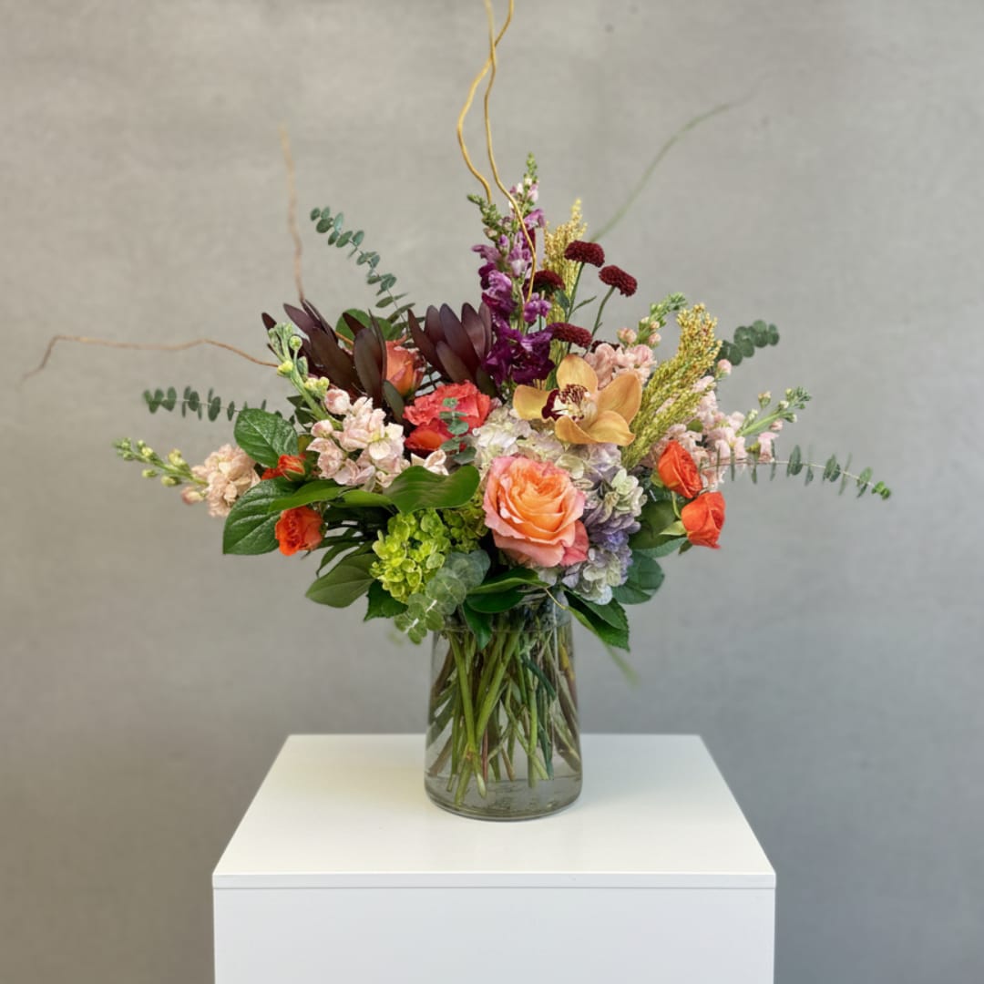 Mixed floral arrangement in a clear glass vase