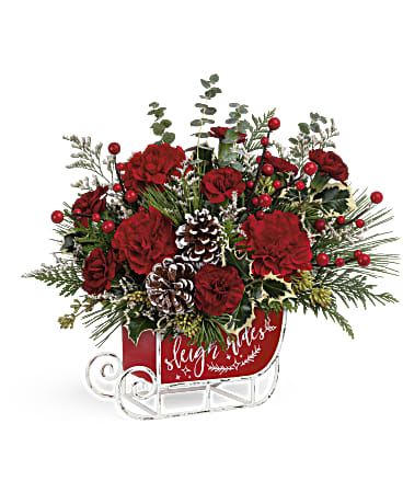 Red floral sleigh arrangement with pinecones and berries