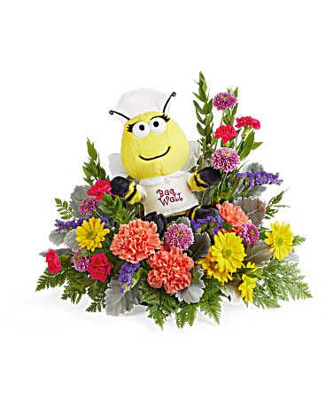 Colorful flower arrangement with a bee plush centerpiece
