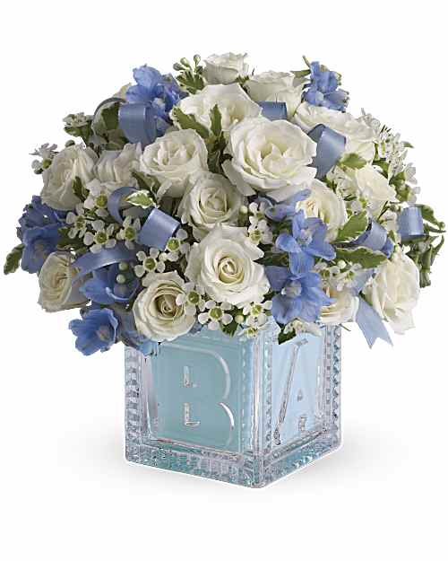 Baby's First Block by Teleflora - Blue - He'll be building block towers soon enough! For now, celebrate him with this beautiful keepsake baby block. Filled with soft blues and whites, the glass block can be used later in baby's room and makes a memorable baby boy gift.