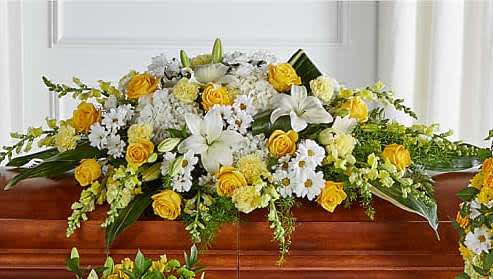Golden Harmony Casket Spray. - Whether yellow was their favorite color or it captures the essence of their radiance, a ring of bright blooms thoughtfully displays your sentiment. Our Golden Harmony Casket Spray. is composed of spray roses, daisy pompons, carnations and more. Each flower is selected to beautifully accent one another and the love you are sending.This gloriously golden sympathy  features traditional arrangement  meant for celebrating the life of a loved one at a visitation, funeral, church service, or cemetery service –