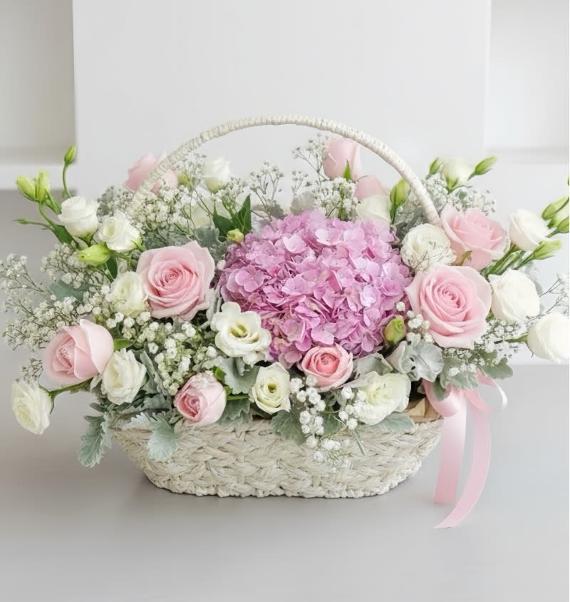 Delicate  beauty Flower Basket - Embrace the serene beauty of our elegant arrangement featuring, Hydrangea, Baby Breath Roses all accented with lush green fillers  Order now to bring a touch of tranquillity and elegance to any space or to delight someone special with this timeless floral display!
