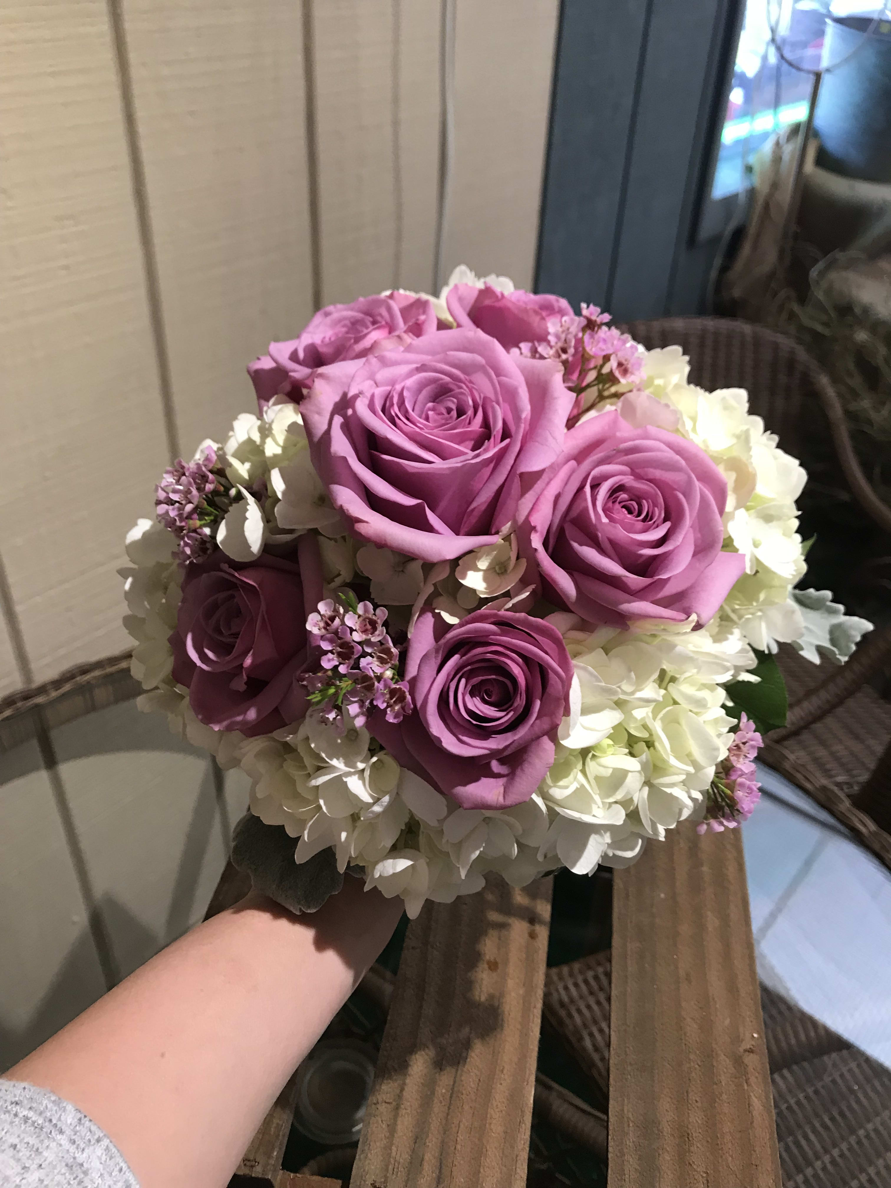 Lavender Love Clutch Bouquet - A Clutch Bouquet made up of lush lavender roses, white hydrangea &amp; lavender wax flower. 