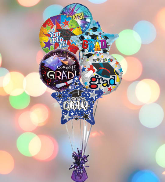 Cluster of graduation-themed balloons with a purple weight at the bottom