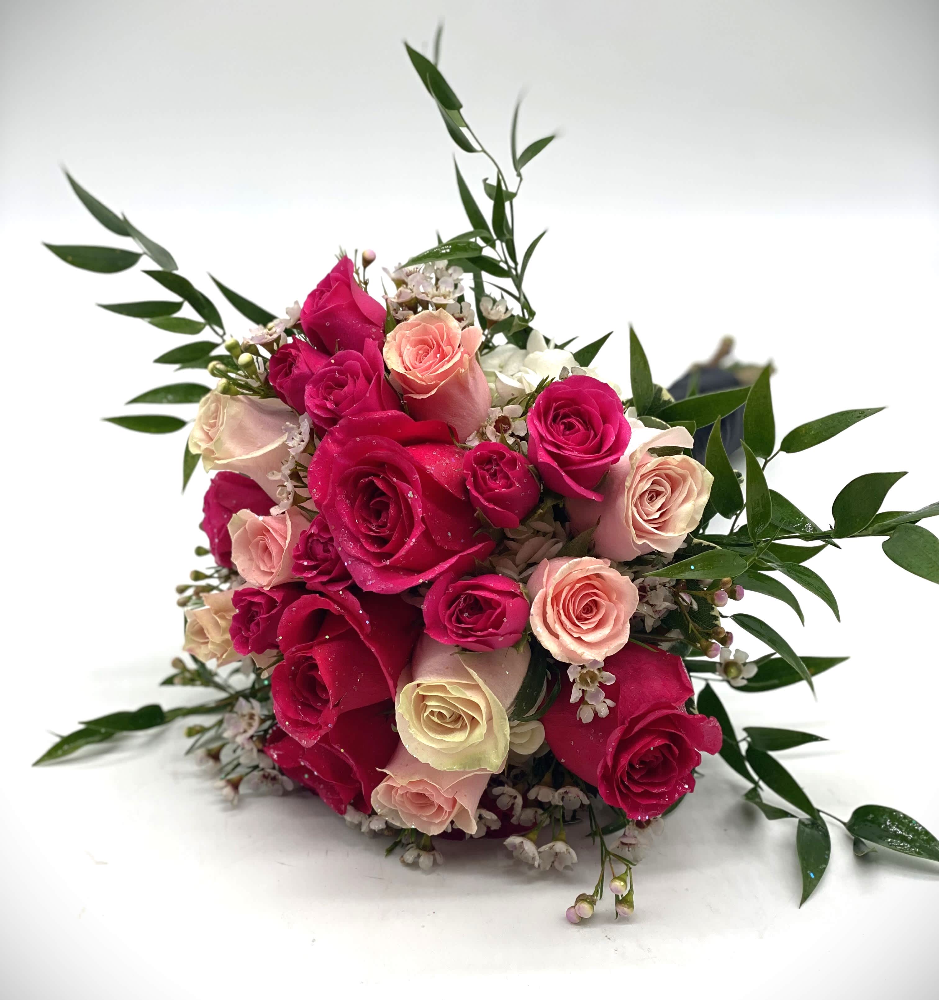 Pretty In Pink Clutch Bouquet - A gorgeous mix of hot pink &amp; light pink roses and spray roses. Finished off with glittle to really make it stand out!