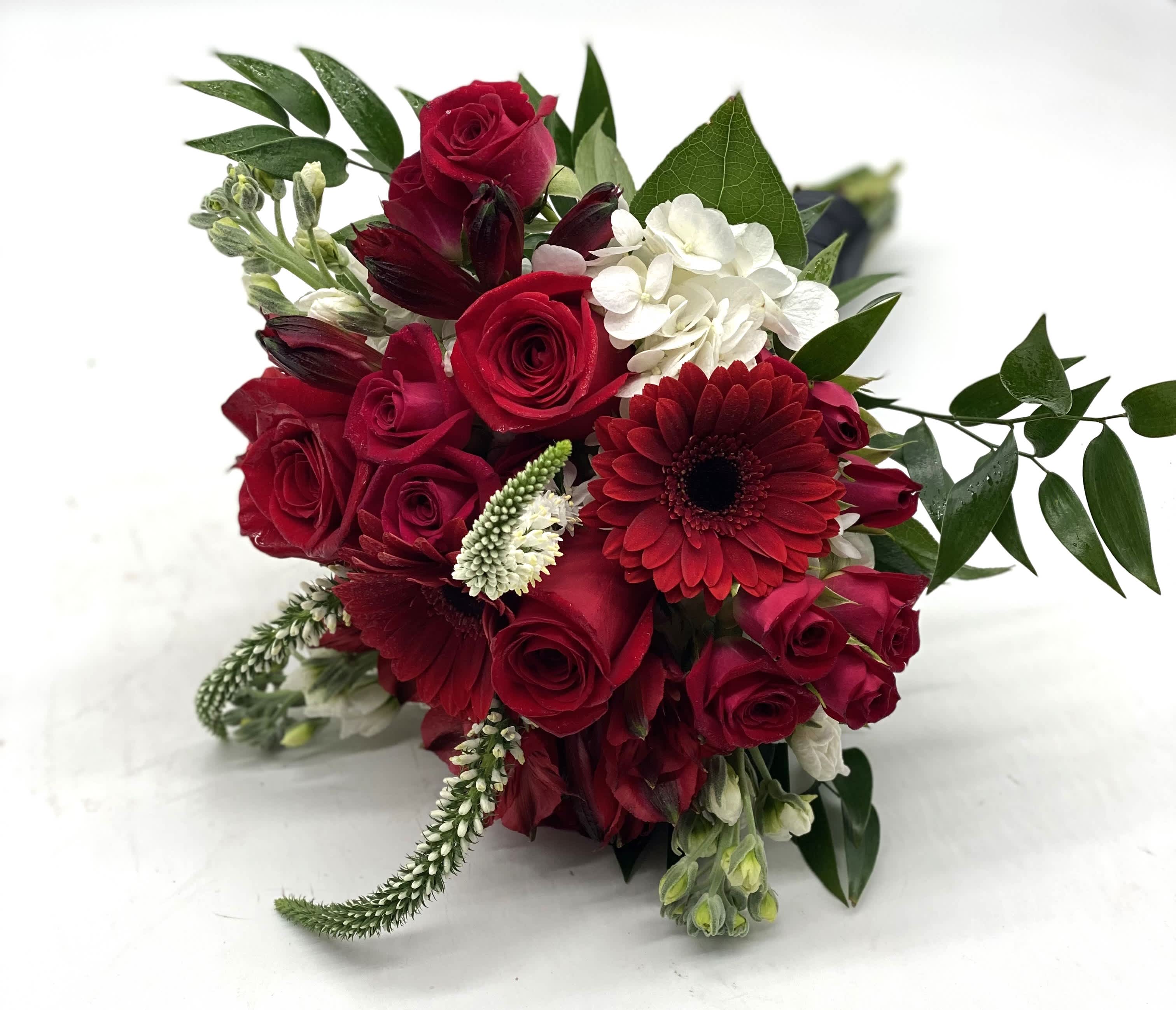 Red Passion Clutch Bouquet - A lush mix of reds with touches of white throughout. 