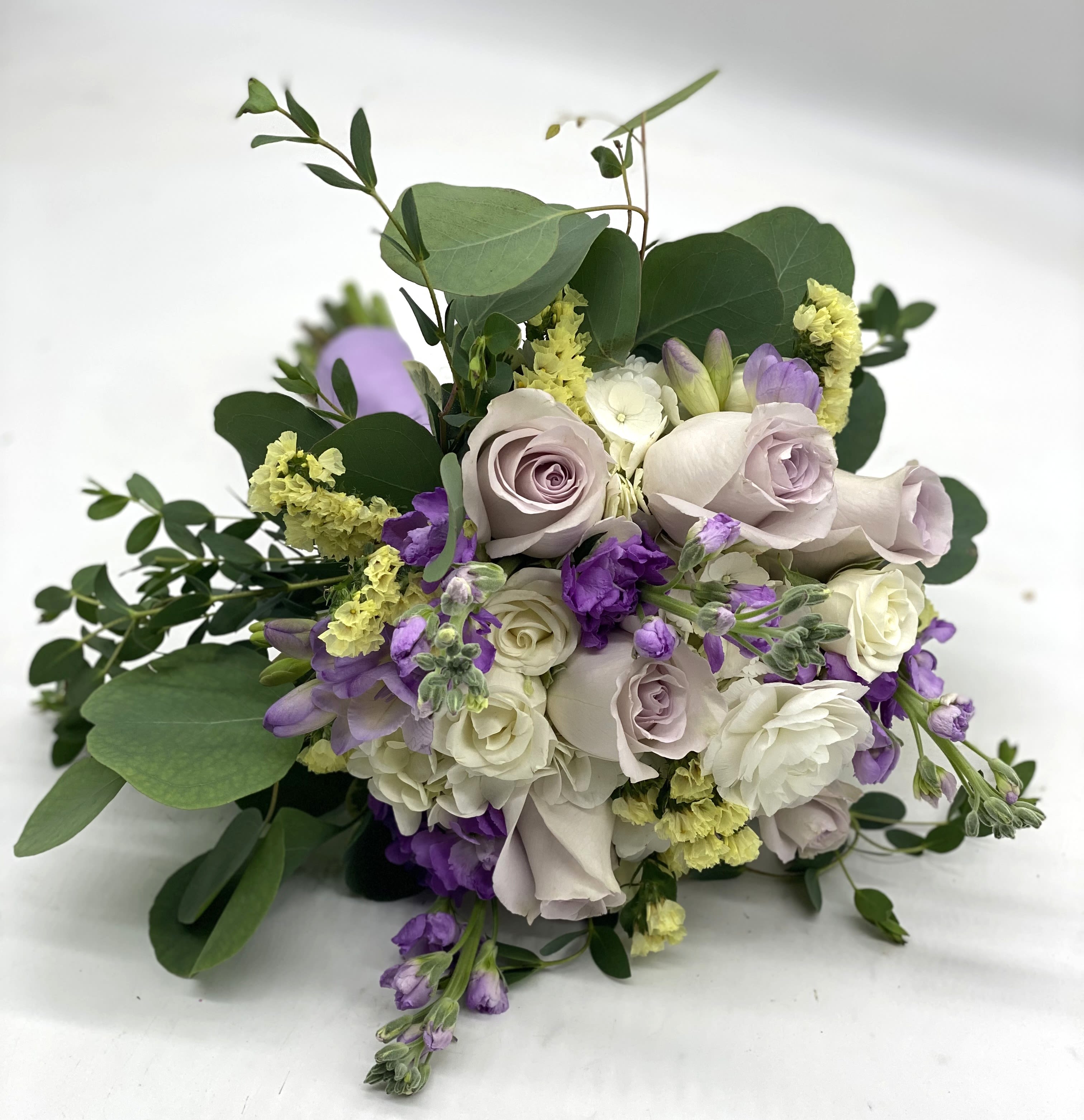 Lavender Starlight Clutch Bouquet - White Hydrangea, Lavender Rose, White Spray Roses, Pale Yellow Statice finished off with flowy eucalyptus