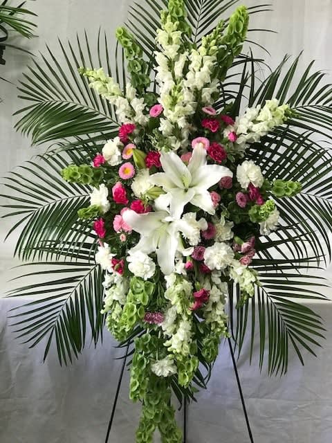 Tall standing floral spray with white lilies and pink flowers